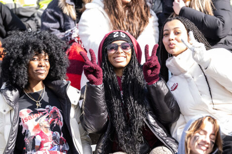 A student gives peace signs in the crowd.