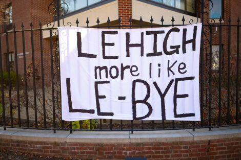 A white bedsheet banner reads 