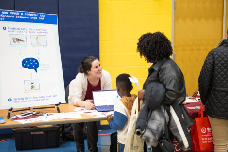 Sofia Serrano, assistant professor of computer science, and Lauren Biernacki, assistant professor of electrical and computer engineering/computer science at a table during Computer Science Night