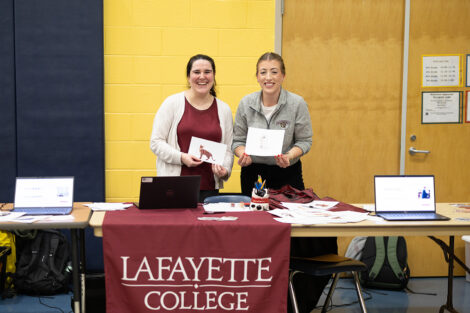 Sofia Serrano, assistant professor of computer science, and Lauren Biernacki, assistant professor of electrical and computer engineering/computer science at a table during Computer Science Night