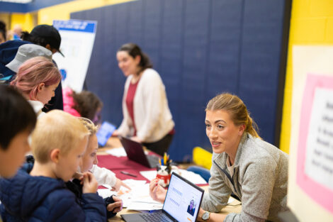 Sofia Serrano, assistant professor of computer science, and Lauren Biernacki, assistant professor of electrical and computer engineering/computer science at a table during Computer Science Night