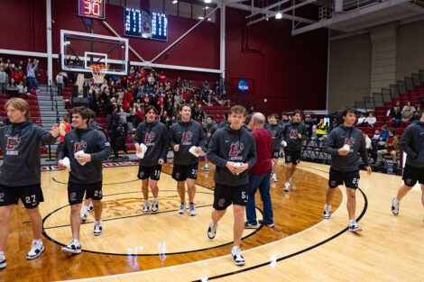 Men's lacrosse team throws t-shirts to Easton students during School Day Game.