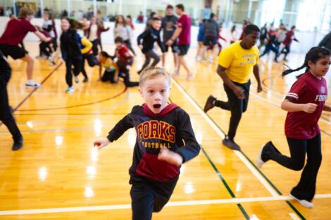 A young Easton student is all smiles as he runs across the basketball court.