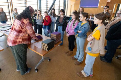 Girl Scouts observing a demonstration on book binding during Lafayette's Girl Scout Badge Day