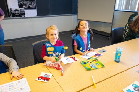 Young Girl Scouts smiling for the camera during Lafayette's Girl Scout Badge Day