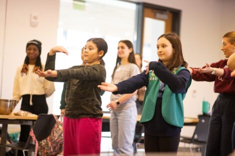 Girl Scouts learning about coding through a dance party activity at Lafayette's Girl Scout Badge Day