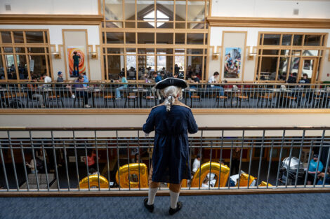 Chris Taverner '25 prepares to read the college charter.