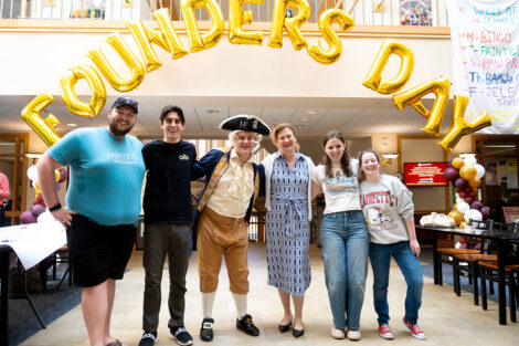 President Nicole Hurd (center) stands with students and staff. one student is dressed as Marquis de Lafayette.