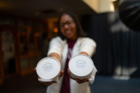 A student holds up two ice cream flavors.