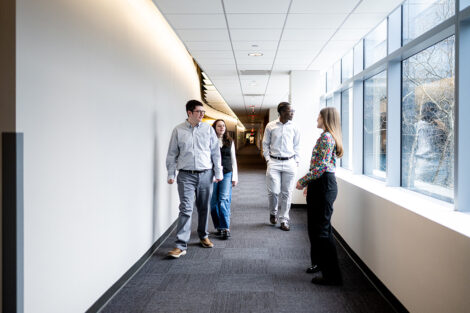 An alum walks students through a hallway of NBCUniversal.