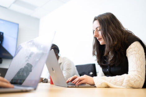 A student types on a laptop.