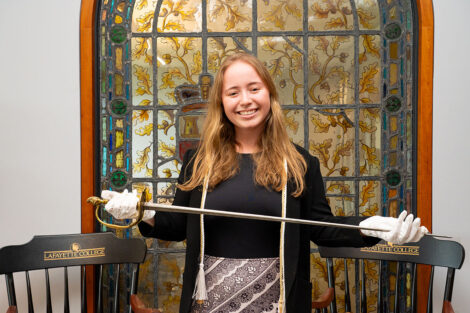 Lauren Daniels raises the Marquis de Lafayette sword.