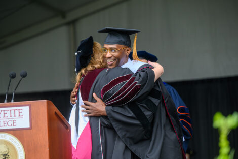 M.K. Asante hugs President Hurd.