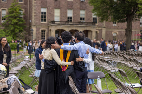Graduates embrace their family and friends.