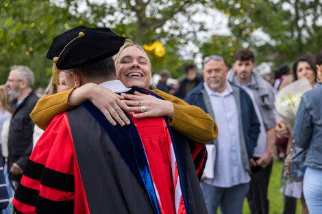 Graduates embrace their family and friends.