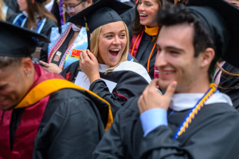 Graduates cheer for each other.