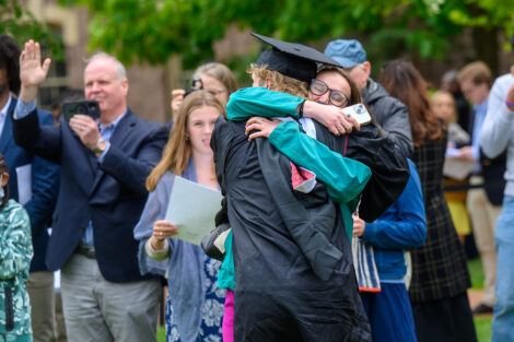 Graduates embrace their family and friends.
