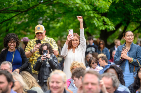 Family members cheer from the crowd.