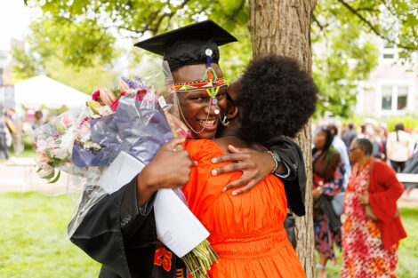 Graduates embrace their family and friends.