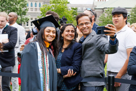 A graduate smiles with her family