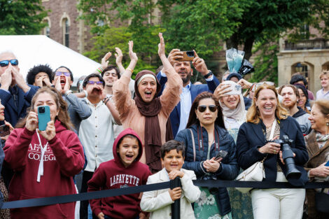 Family members cheer from the crowd.