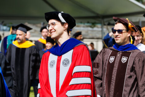 Lead by the Leopard, rows of faculty, staff, and students process into Commencement.
