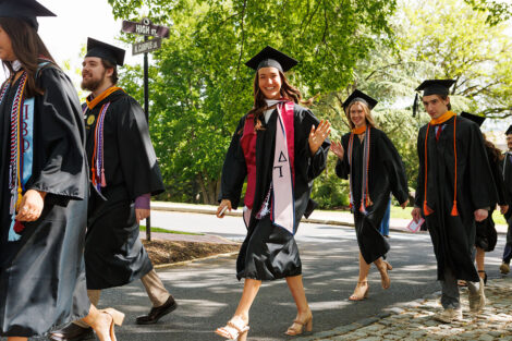 Lead by the Leopard, rows of faculty, staff, and students process into Commencement.