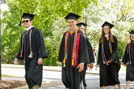 Lead by the Leopard, rows of faculty, staff, and students process into Commencement.