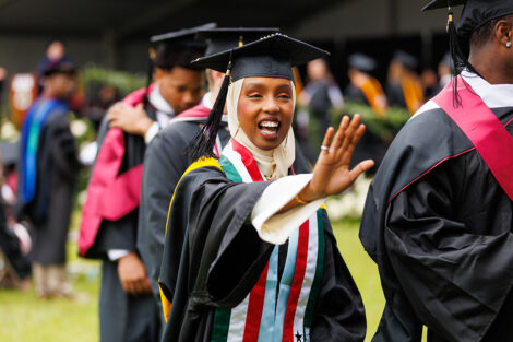 A graduate waves