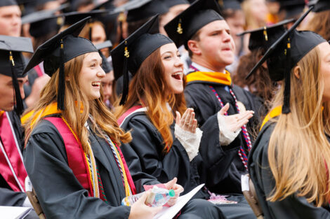 Graduates cheer for each other.