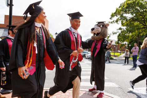 Lead by the Leopard, rows of faculty, staff, and students process into Commencement.