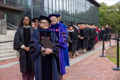 Rows of faculty, staff, and students process into Commencement.