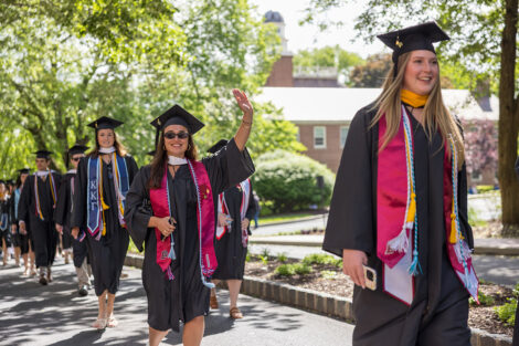 A student waves during the procession.