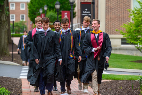 Graduates walk toward the Quad.