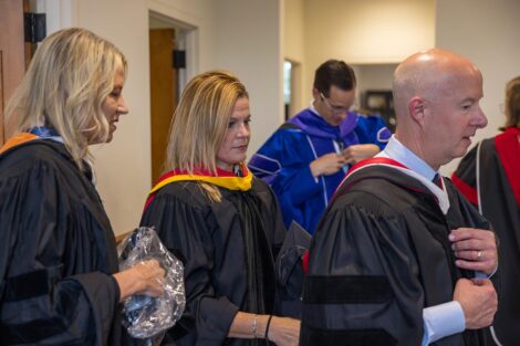 Senior Leadership Team and Board of Trustees prepare for Commencement.