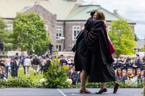 A graduate hugs President Hurd.