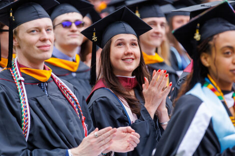 Graduates cheer for each other.
