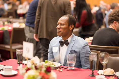 A professor smiles during the Faculty Staff awards ceremony.