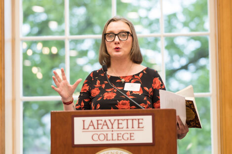 Alex Hendrickson speaks at a podium.