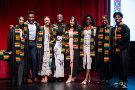Students smile at the Donning of the Kente.