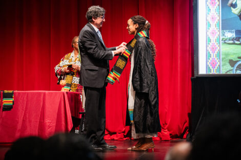 A student gets a stole at the Donning of the Kente