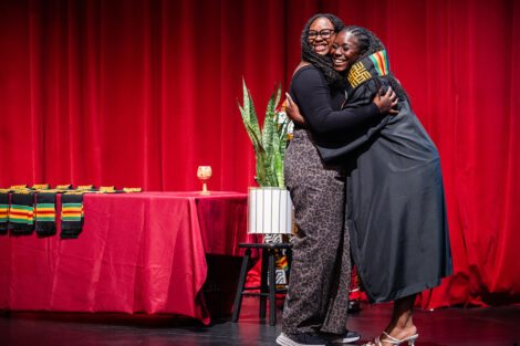 Students hug at the Donning of the Kente