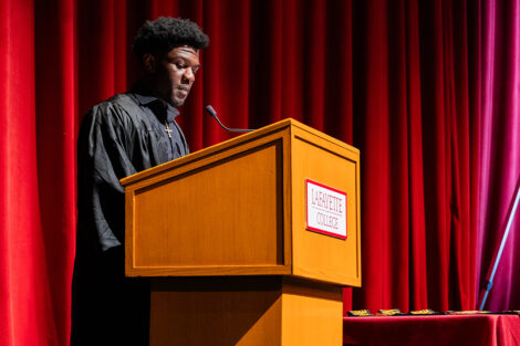 A student speaks at the Donning of the Kente