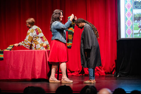 A student gets a stole at the Donning of the Kente