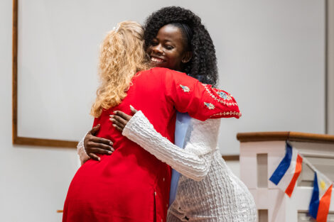 A student hugs a staff member at International Celebration