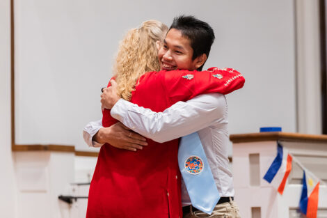 A student hugs a staff member at International Celebration