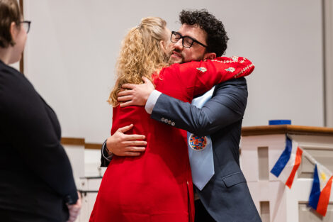 A student hugs a staff member at International Celebration