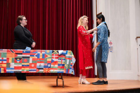 A student gets their stole at the international celebration.
