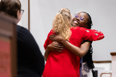A student hugs a staff member at International Celebration