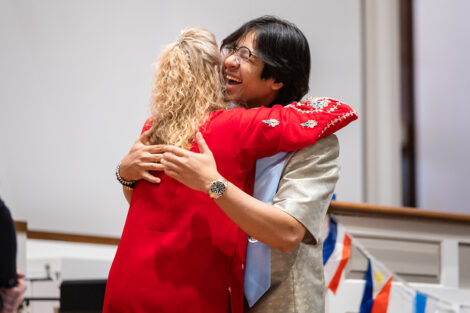 A student hugs a staff member at International Celebration